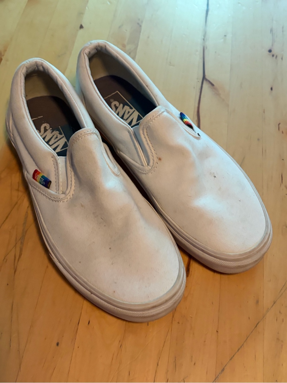 Vans White Slip-On Sneakers with Rainbow Heel Stripe